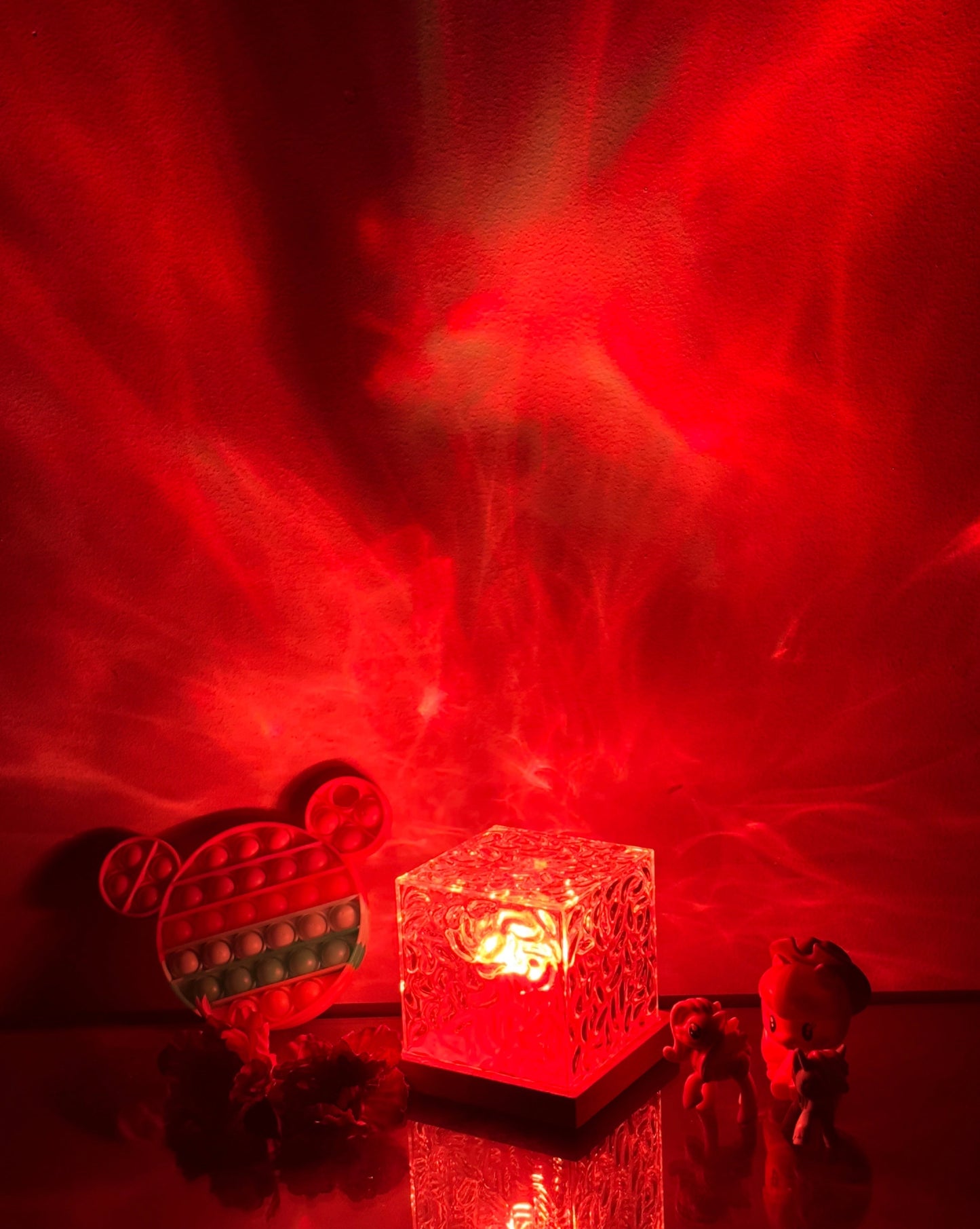 Northern Lights Inspired Cube Lamp emits a colorful glow resembling the aurora borealis, with shades of red and magenta, creating a vibrant, atmospheric lighting effect.