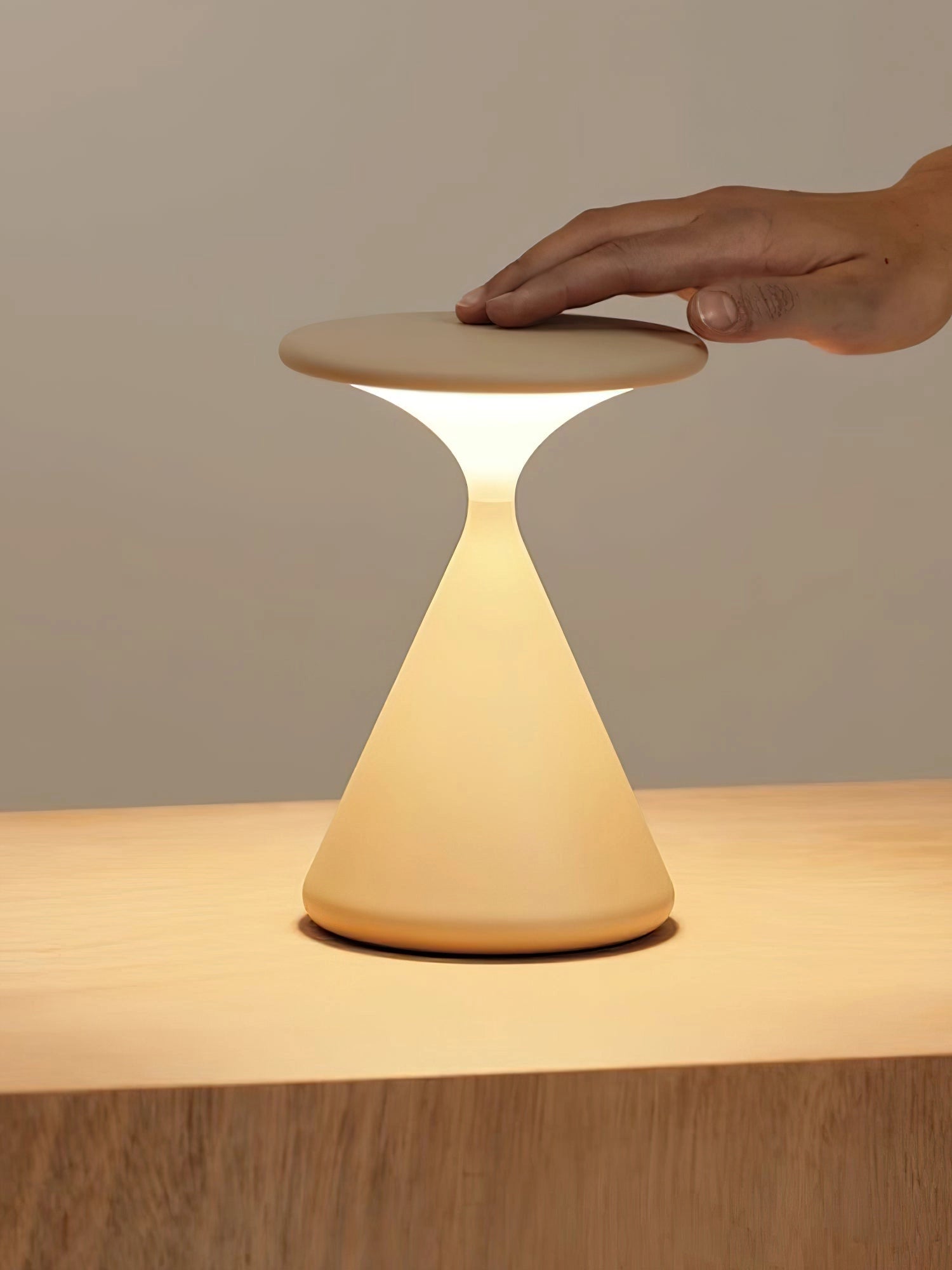 Outdoor Cordless Lamp for Portable Ambiance - Selene, Versatile and Elegant, placed on a wooden table with a chair nearby, showcasing its elegant design and sturdy build.
