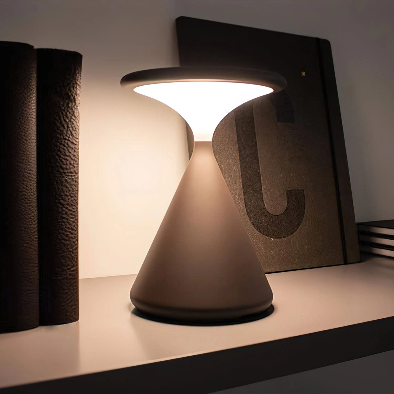 Elegant and versatile Selene outdoor cordless lamp with a rectangular wooden base, emitting a warm, ambient glow suitable for any outdoor setting.
