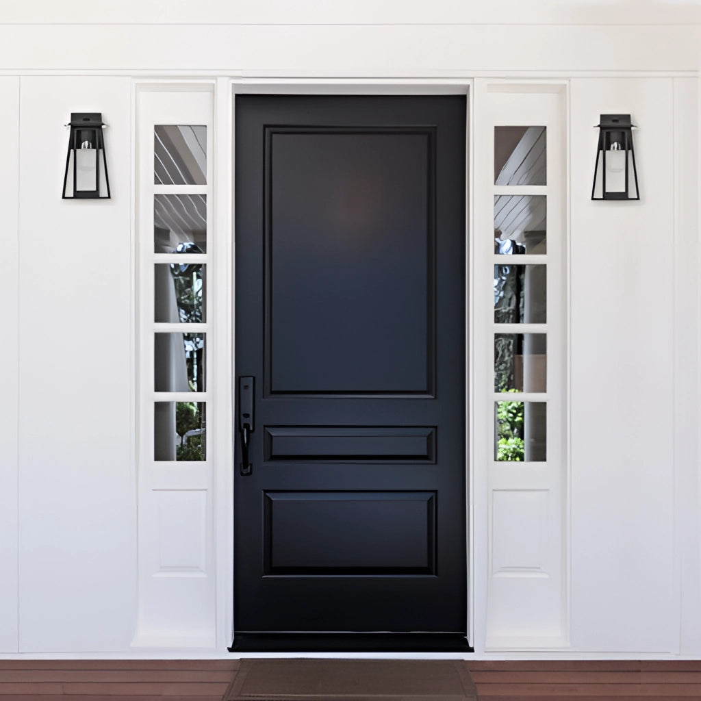 Black steel outdoor wall lantern sconce with glass panels mounted beside a wooden home door, featuring a rectangular design and handle.