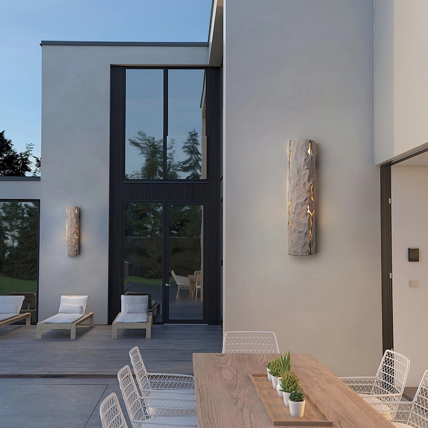 Outdoor wall light with IP65 waterproof rating, featuring a premium resin faux rock finish, mounted on a building exterior next to plants.