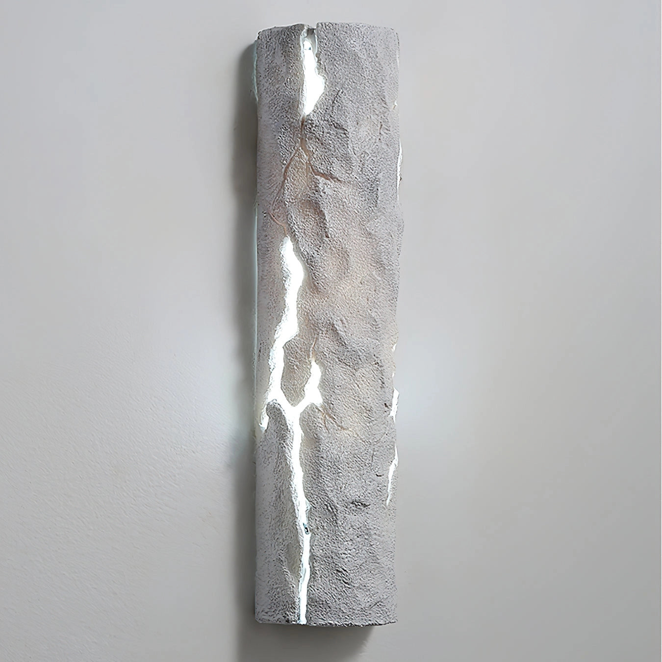 Outdoor wall light with IP65 waterproof rating and premium resin faux rock finish, featuring a cylindrical glass and metal design.