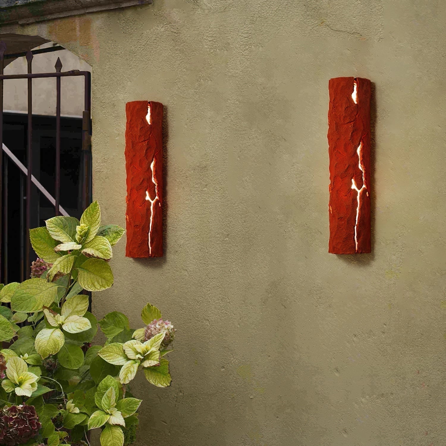 Outdoor wall light with IP65 waterproof rating, featuring a premium resin faux rock finish, mounted on an exterior wall near a window with surrounding plants.