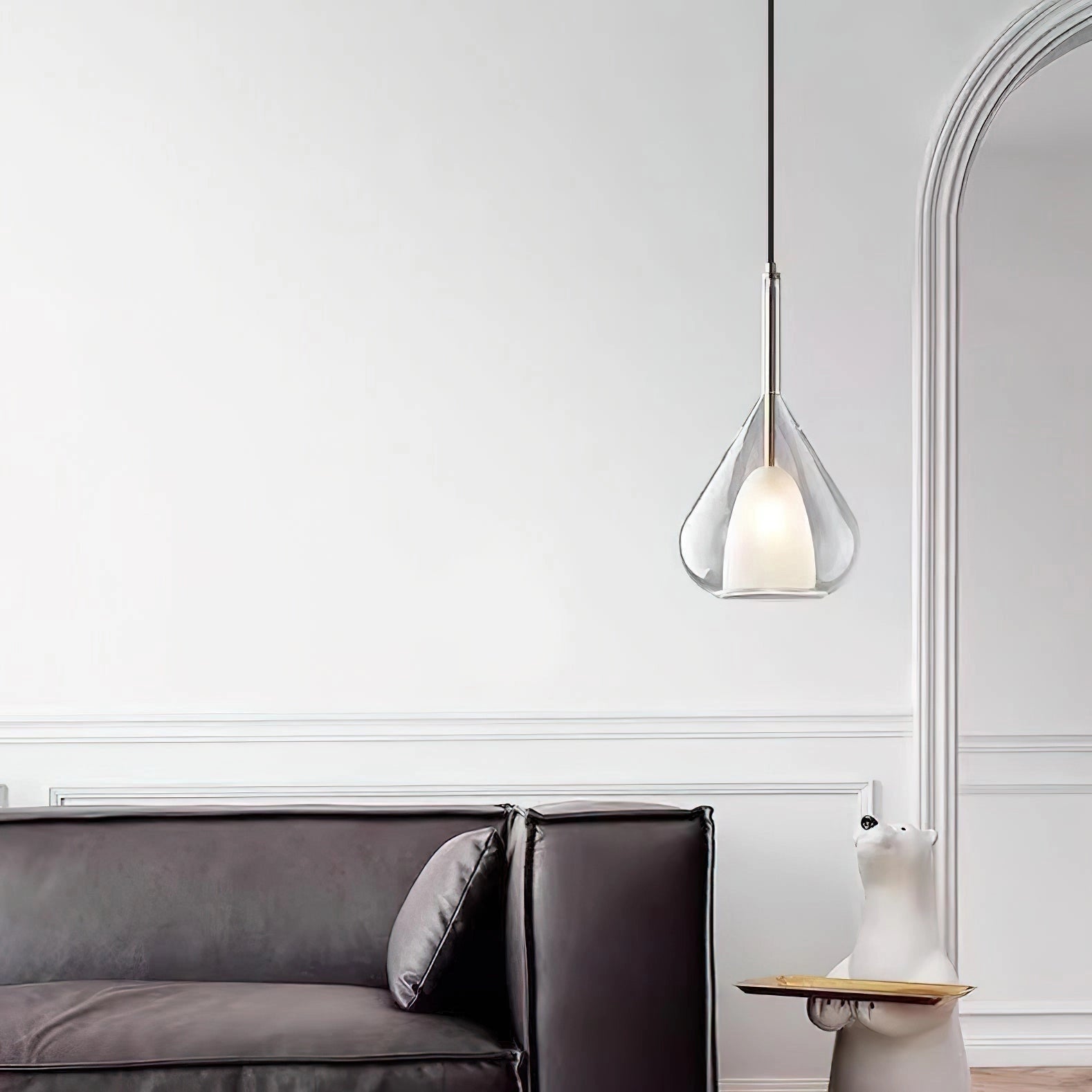 Nordic style pendant lamp with a clear raindrop design and starlight effect, featuring a wooden accent, hanging in a modern grey-toned interior.