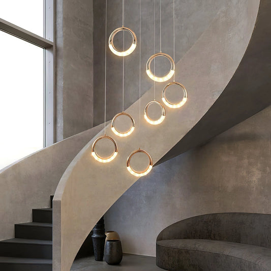 Modern wooden pendant lamp Dante hanging from the ceiling in an elegantly designed interior space, featuring artistic elements and sophisticated lighting.