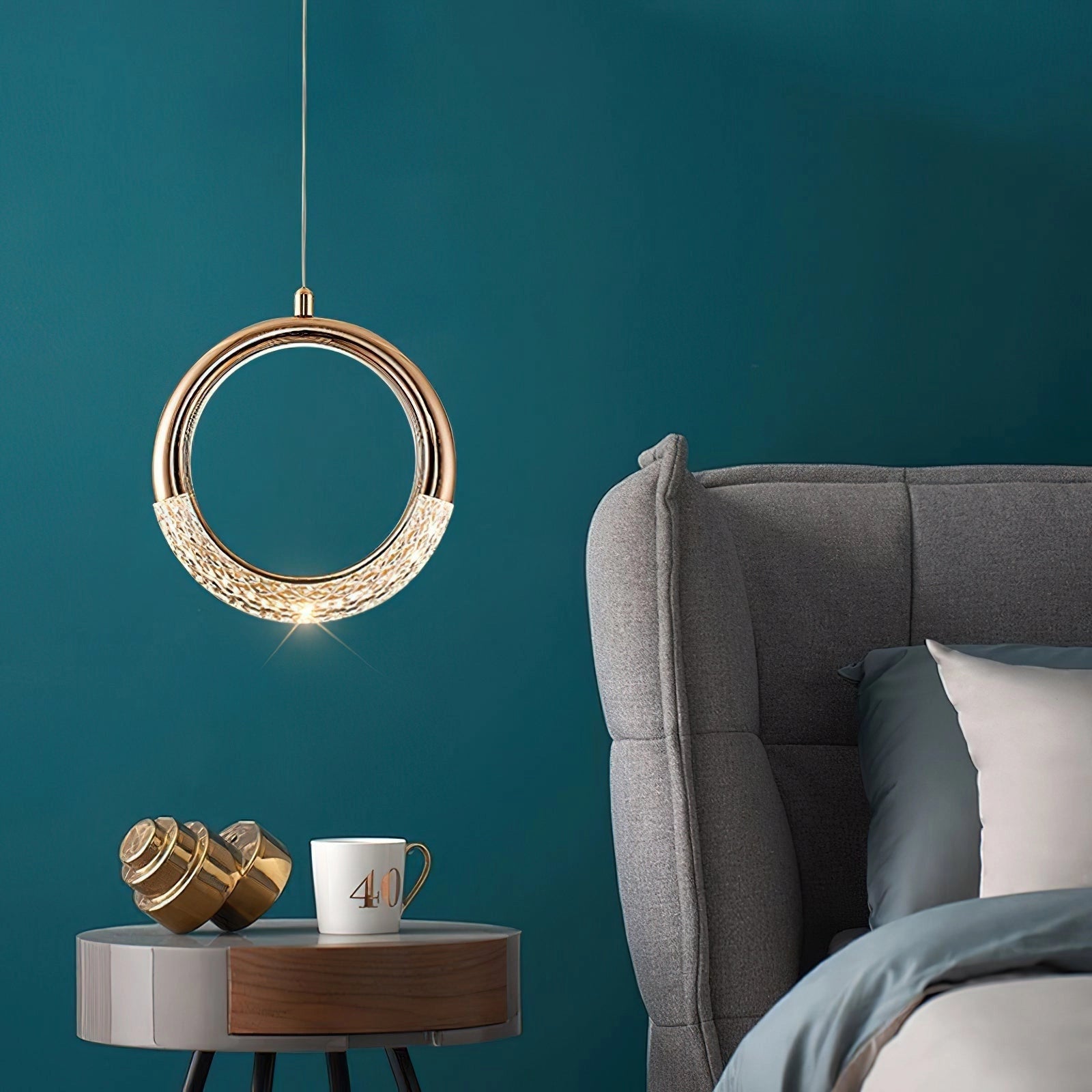 Modern Pendant Lamp Dante hanging over a stylish dining table set in an elegantly designed interior with comfortable furniture and aqua accents.