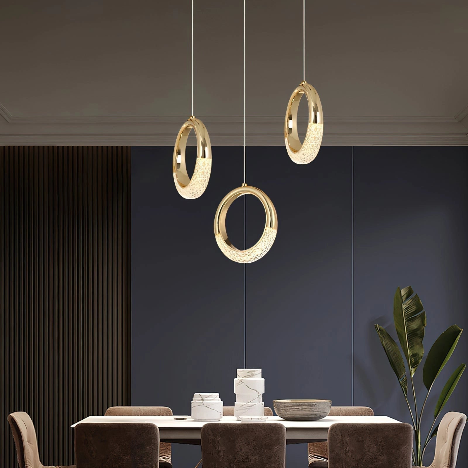 Modern pendant lamp Dante in a stylish interior with wooden table and chairs, potted plants, and large windows.