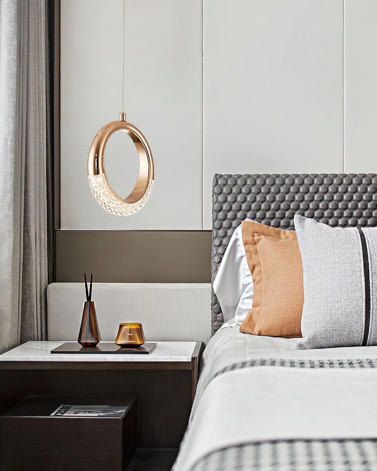 Modern Pendant Lamp Dante chandelier hanging in a stylishly furnished room with grey tones, featuring wood elements, a rectangular mirror, and a comfortable bed with pillows.