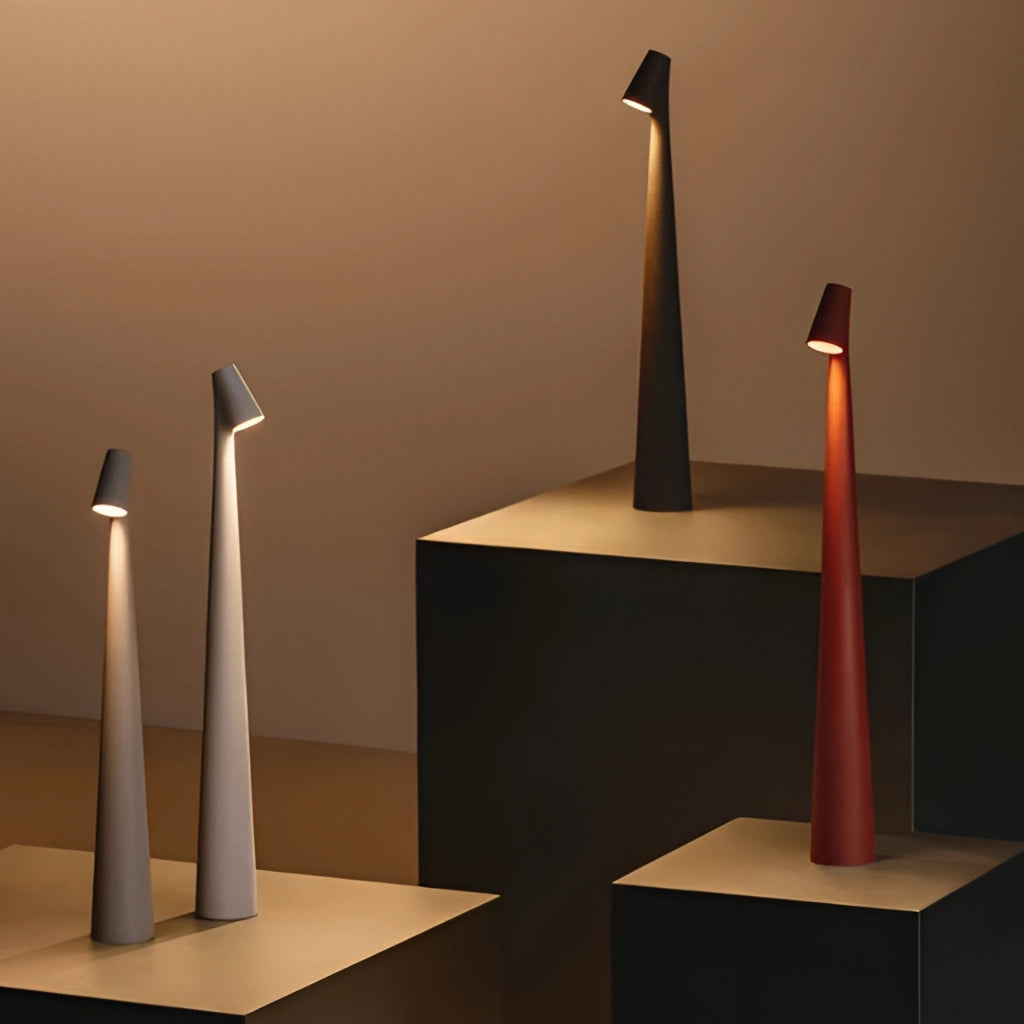 Portable rechargeable LED table lamp with aluminum construction, three light intensities, placed on a wooden surface.
