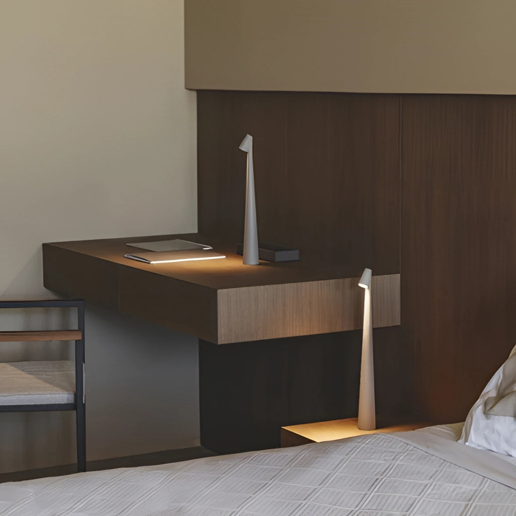 Portable rechargeable LED table lamp with aluminum construction featuring three light intensities, placed on wooden flooring.