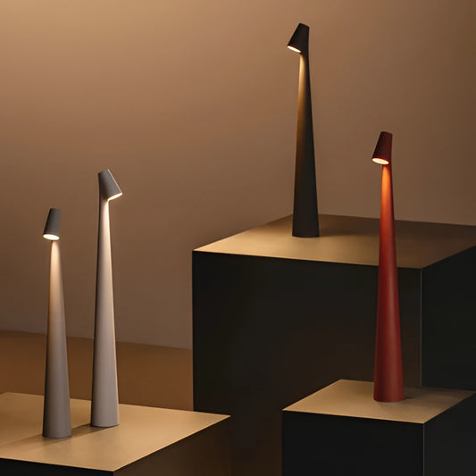 Portable Rechargeable LED Table Lamp made of aluminum, placed on a wooden surface, featuring three adjustable light intensities in a modern interior design setting.