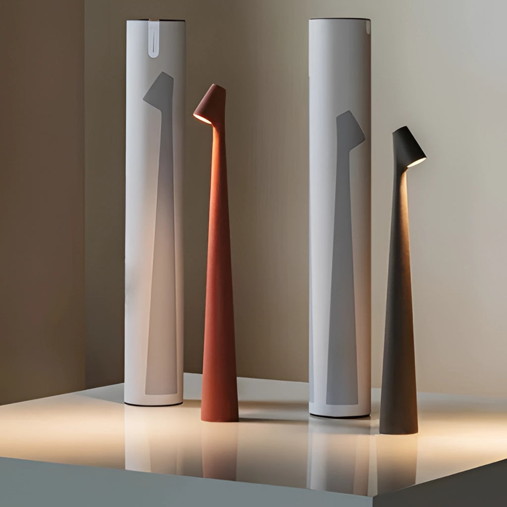 Portable rechargeable LED table lamp made of aluminum with three light intensity settings, displayed on a wooden surface.