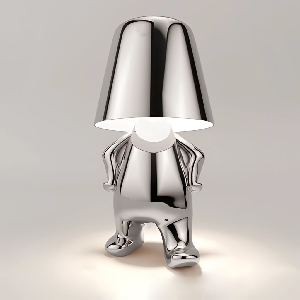 Modern gold thinker statue LED table lamp on a walking silver base.