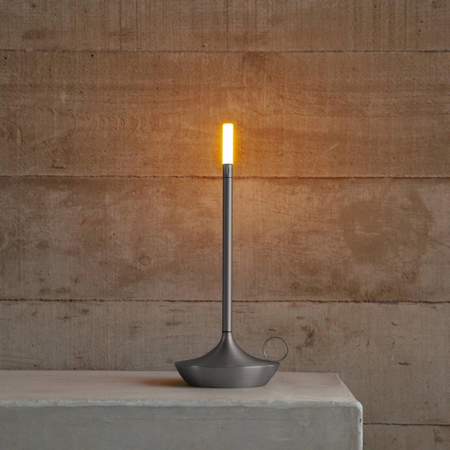 Silver Nordic Candlestick Light with adjustable dimming, rechargeable aluminum casing placed on a wooden surface.