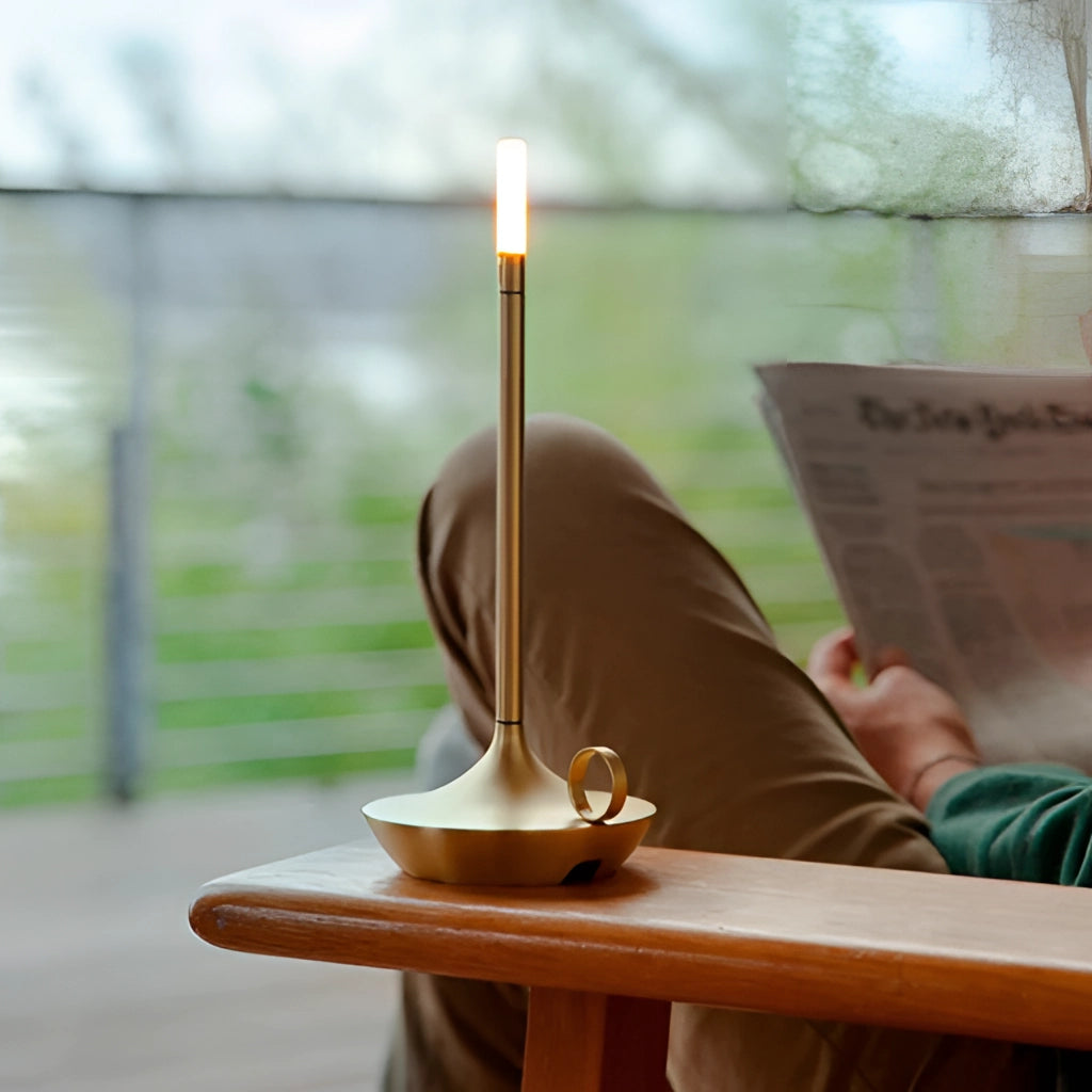 Nordic candlestick light with adjustable dimming and rechargeable aluminum casing on a wooden surface.