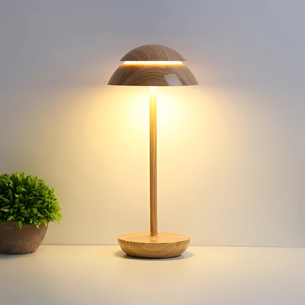 Scandinavian design wooden table lamp with a sleek shade, placed beside a small potted plant.