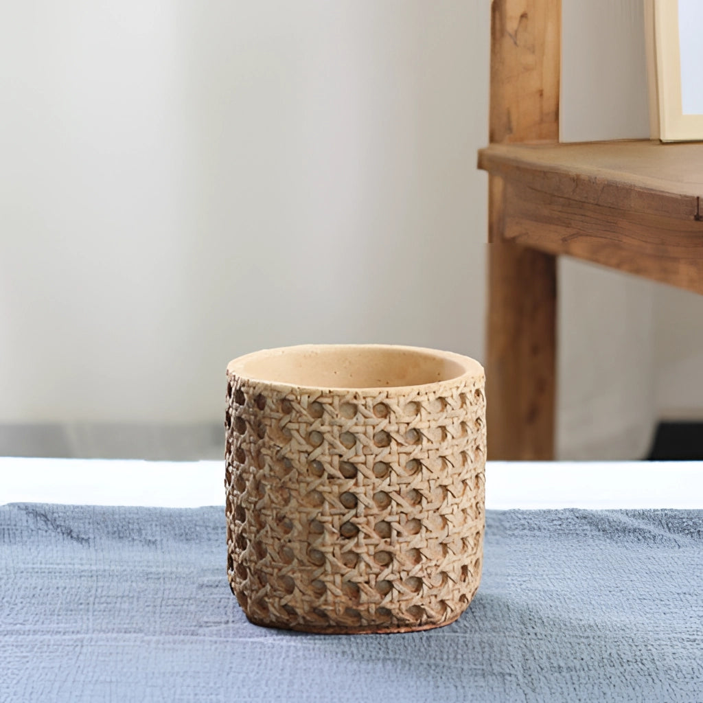 Small Rattan Cement Planter with Natural Texture placed on a wooden table.