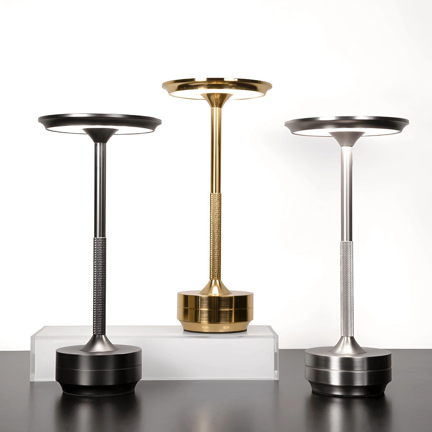 Rechargeable LED table lamp with a sleek, cordless design, featuring a metallic finish and modern aesthetic, ideal for mood lighting in various settings.