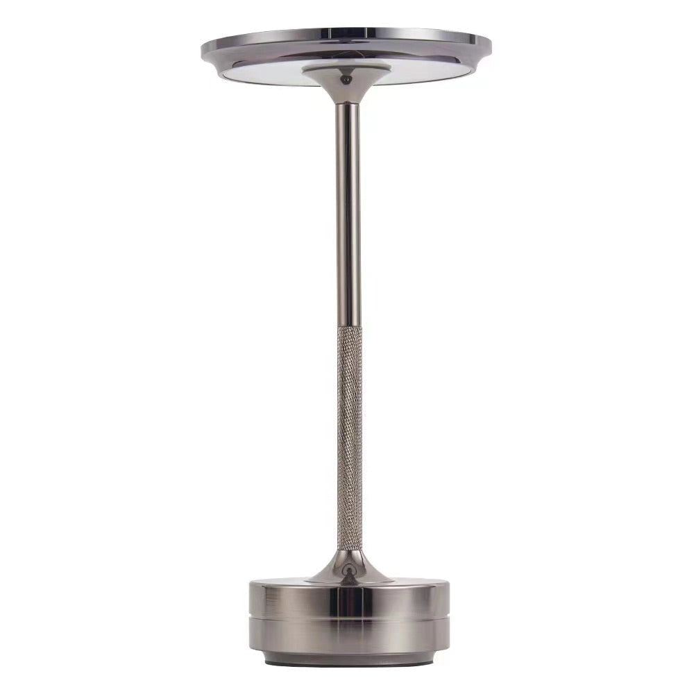 Rechargeable LED table lamp in silver with a sleek metal and glass design, ideal for cordless mood lighting in home settings.