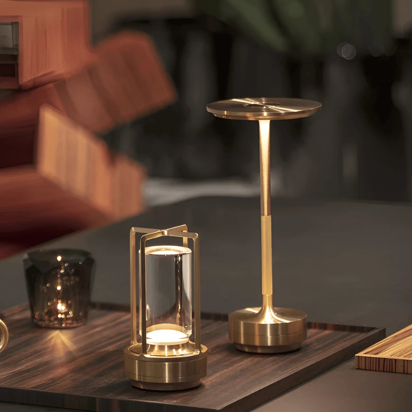 Rechargeable LED table lamp on a wooden table, casting a warm mood lighting in a dark setting, with drinkware and glass items nearby.