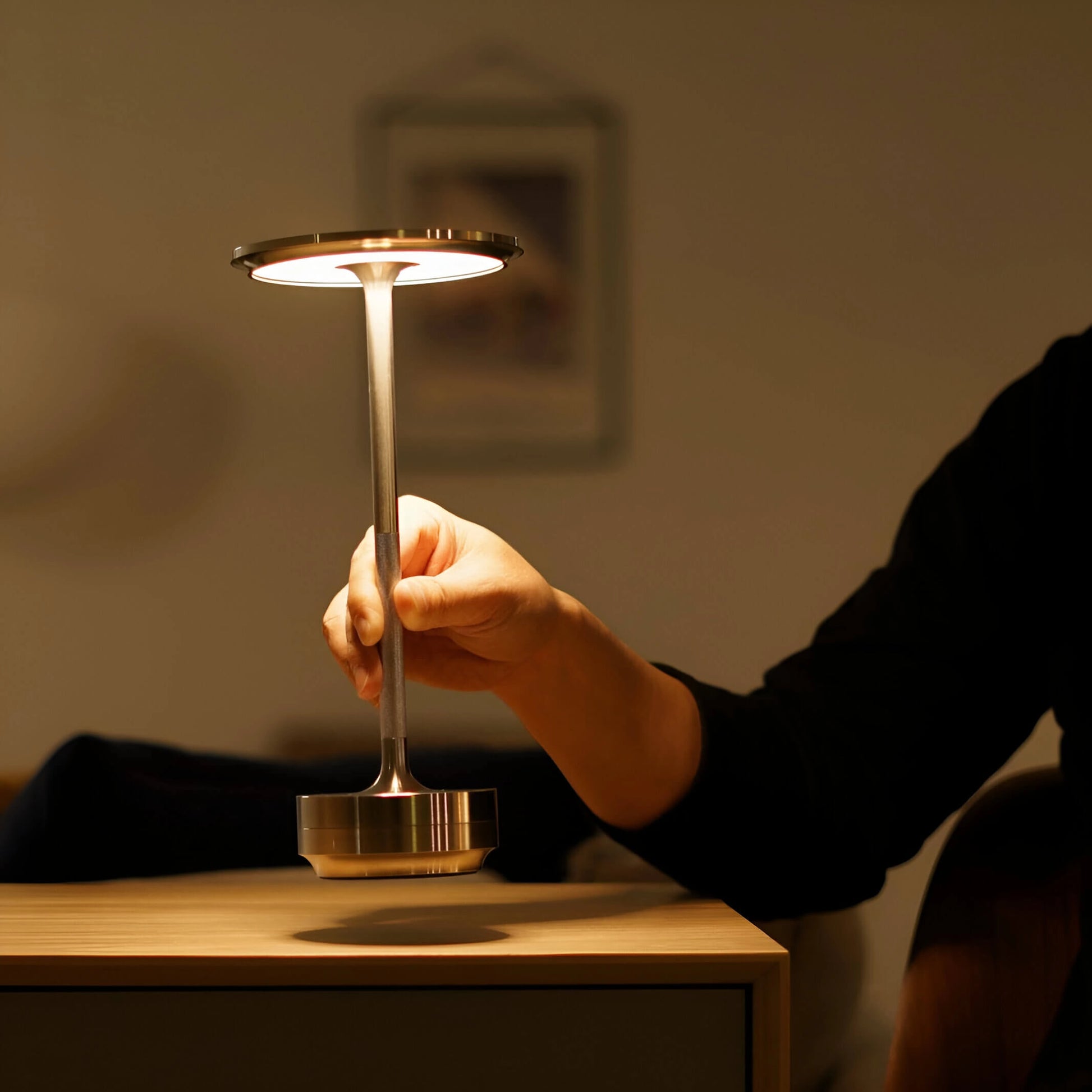 Rechargeable LED table lamp with wood base and glass lampshade, emitting soft mood lighting.