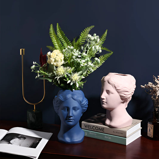 Resin Neoclassical Venus Vase in Blush Pink with plant arrangement, featuring classical sculpture design and artistic flowerpot style.