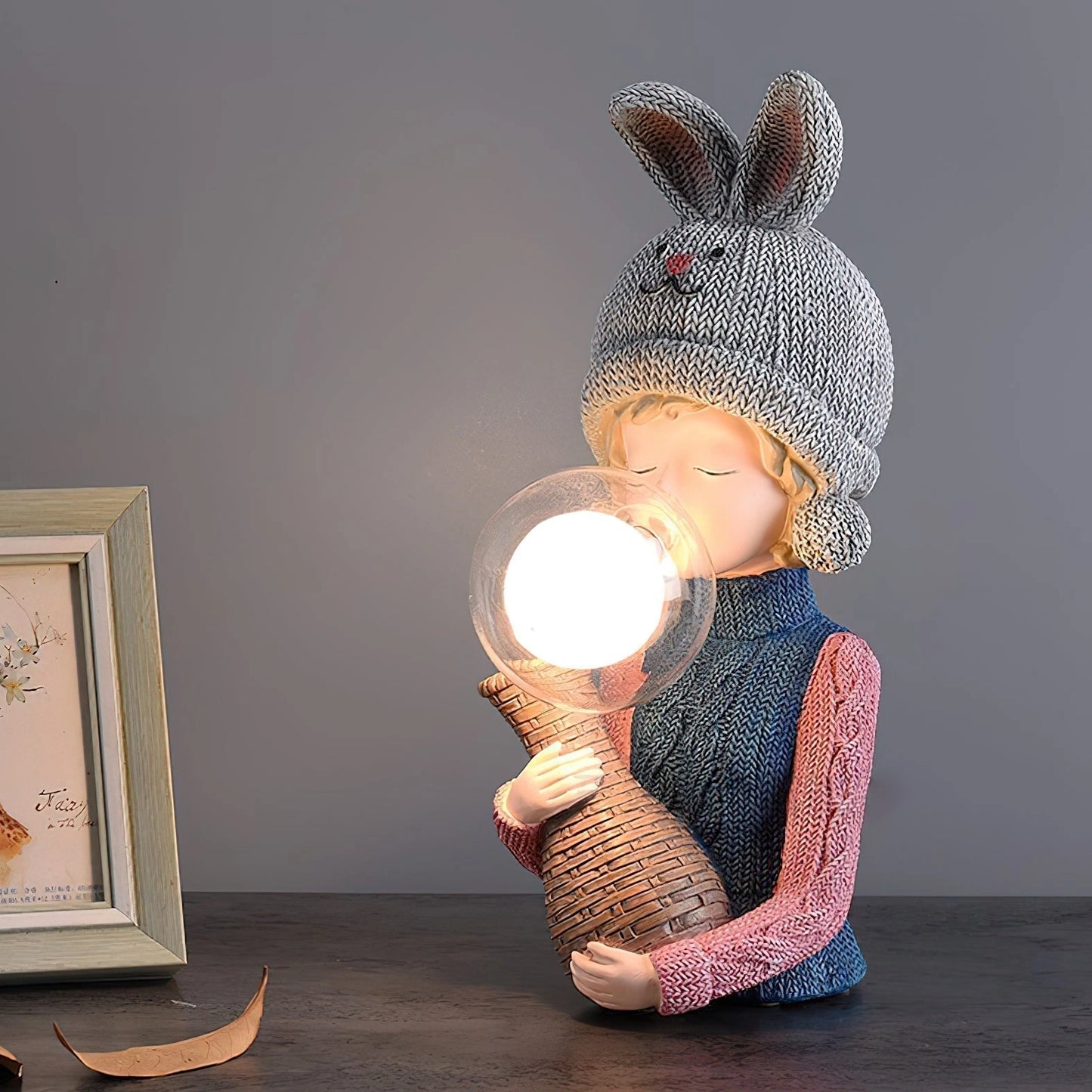 Resin Table Lamp featuring an elegant rabbit girl design with dual glass lampshades, set in a cozy environment with soft lighting.