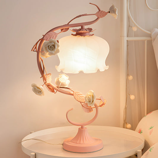 Elegant table lamp with a clear casing encasing a delicate rose, serving as both a light source and floral ornament, perfect for interior design and home decor.