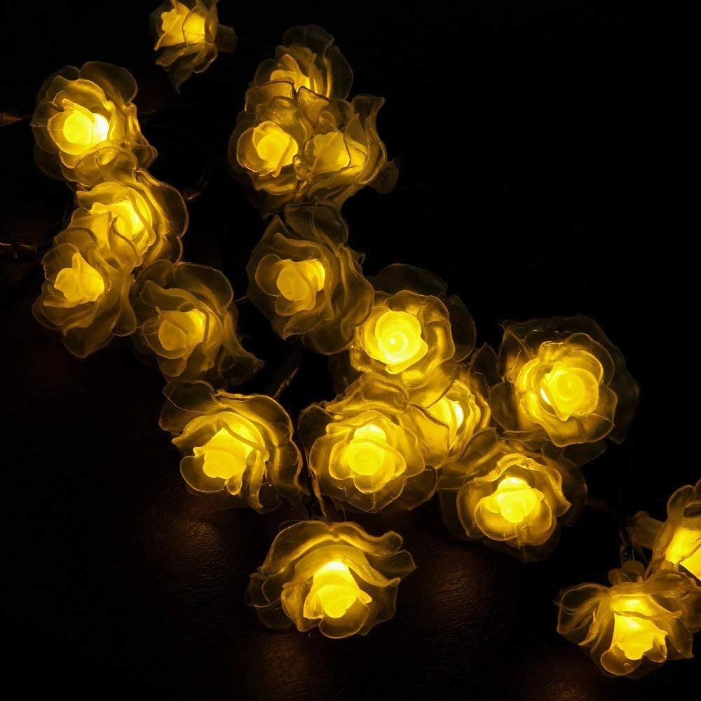 Elegant Rose Style LED String Lights emitting a warm amber glow, arranged in symmetrical circles, illuminating the darkness.