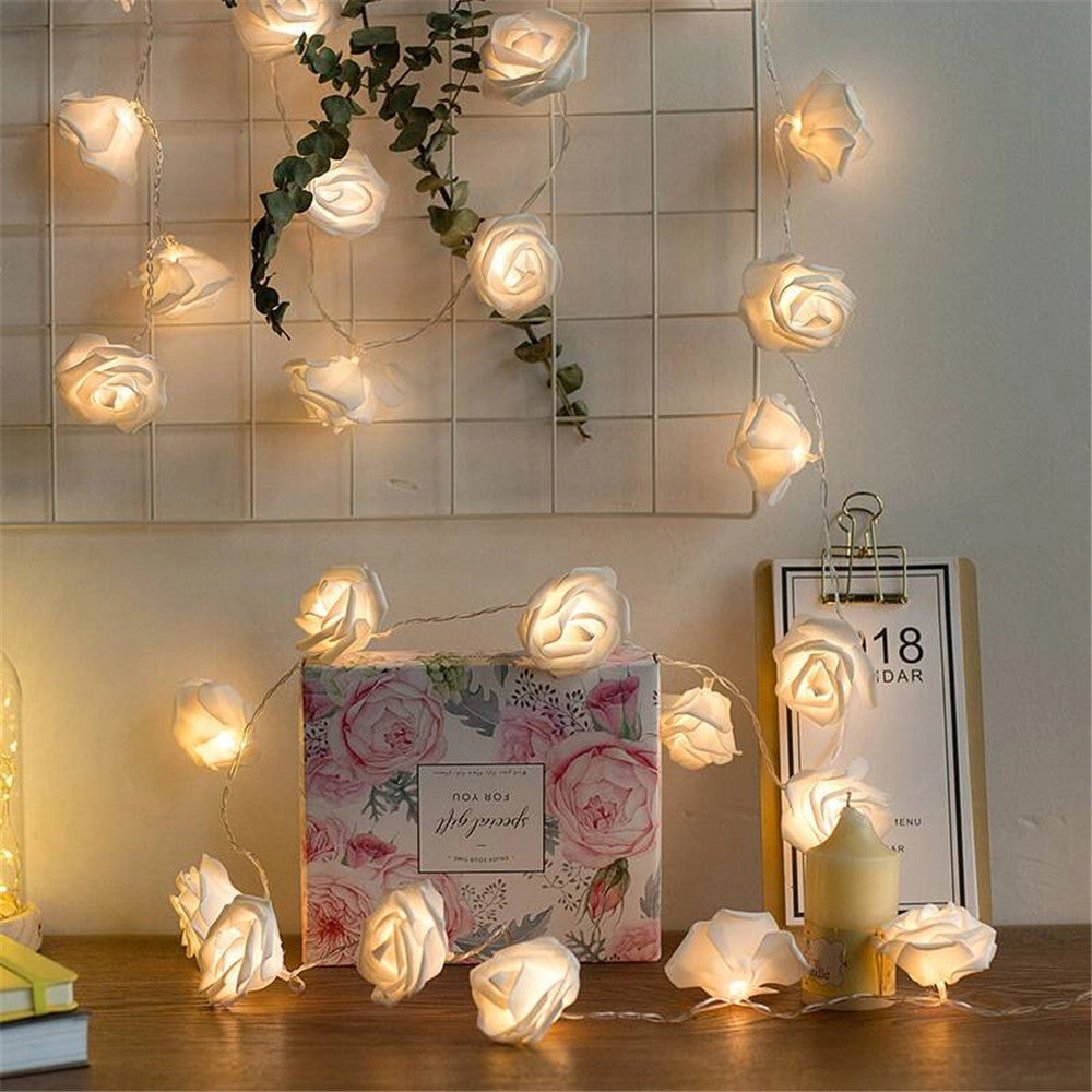 Rose Flower LED String Lights used as decoration in an interior room, illuminating a wall with elegant rose-shaped ornaments.