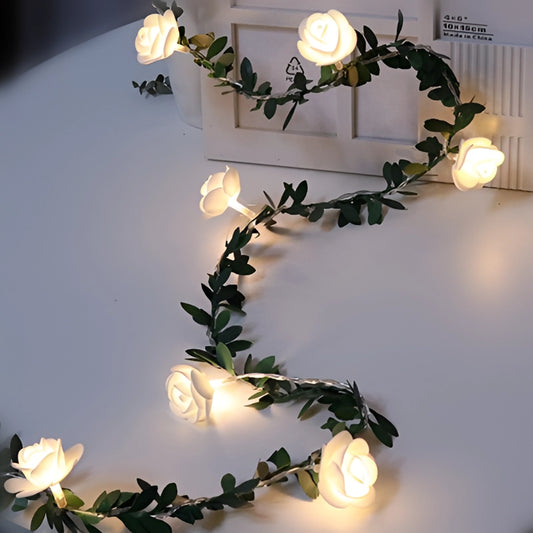 Battery-operated LED rose flower string lights garland with white flowers, resembling branches and twigs, used for decorative lighting and creative arts.
