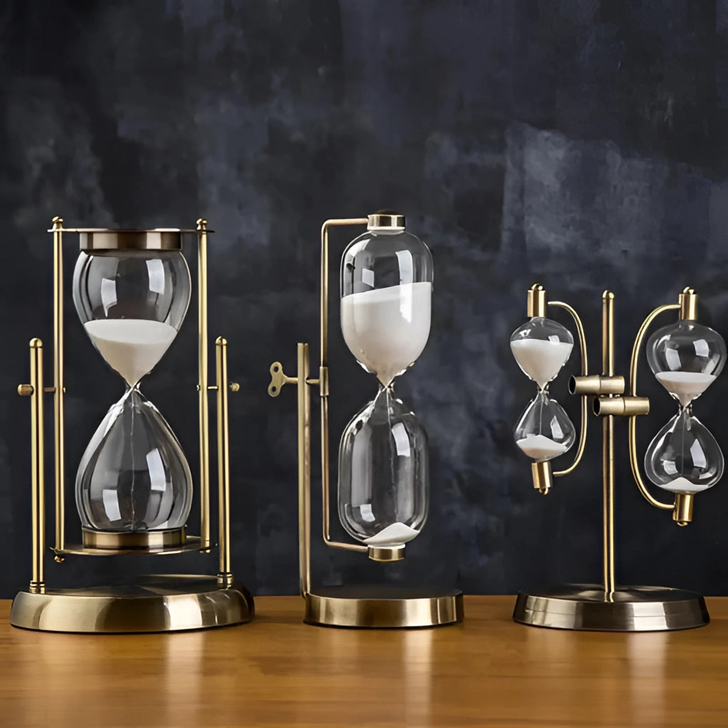 Elegant rotating globe hourglass timer with fine sand, displayed on a table next to sophisticated drinkware including wine glasses and champagne flutes.
