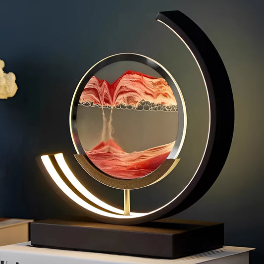 A dynamic 3D sand painting light in an LED table lamp, featuring an orange-hued circular design with flowing sand art enclosed in a sleek, modern frame.