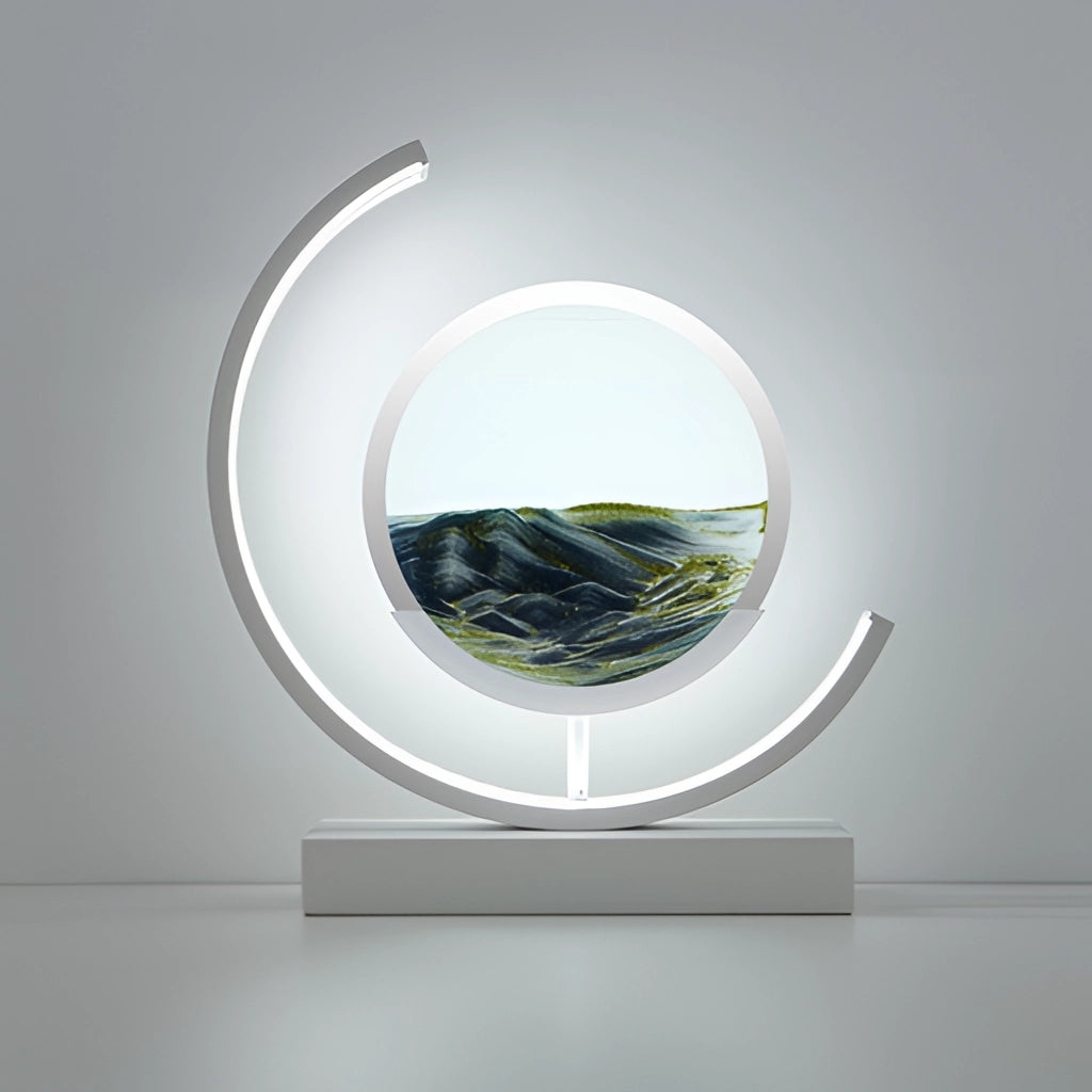 Black and White Sand Art LED Table Lamp displaying dynamic 3D sand painting with a modern rectangular design, placed on a surface alongside a plant.