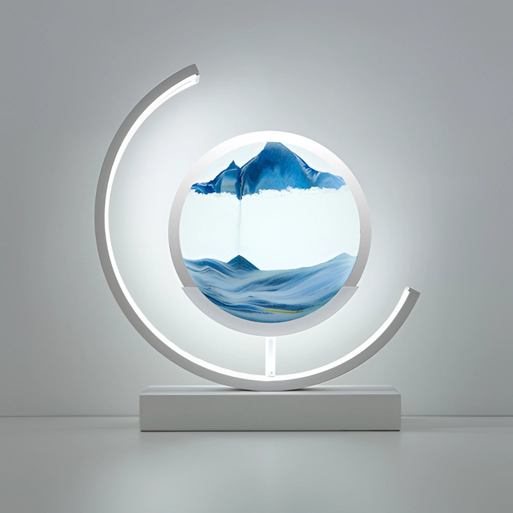 Sand Art LED Table Lamp displaying dynamic 3D sand painting with blue and white sand, illuminated elegantly against a dark background.