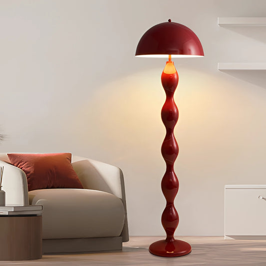 Scandinavian LED Floor Lamp in Red with Adjustable Brightness, featuring a sleek Nordic design, placed in a modern living room with wooden flooring and a comfortable couch.