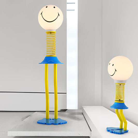 Yellow and blue smiley face design floor lamp with metal and acrylic glass construction, featuring an LED bulb and 110V US plug, suitable for bedroom lighting.