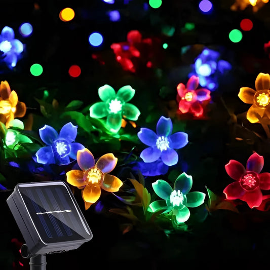 String of solar-powered flower lights shaped like crystal peach blossoms, featuring 100 RGB LED bulbs, waterproof and suitable for outdoor use, illuminating against a night sky.