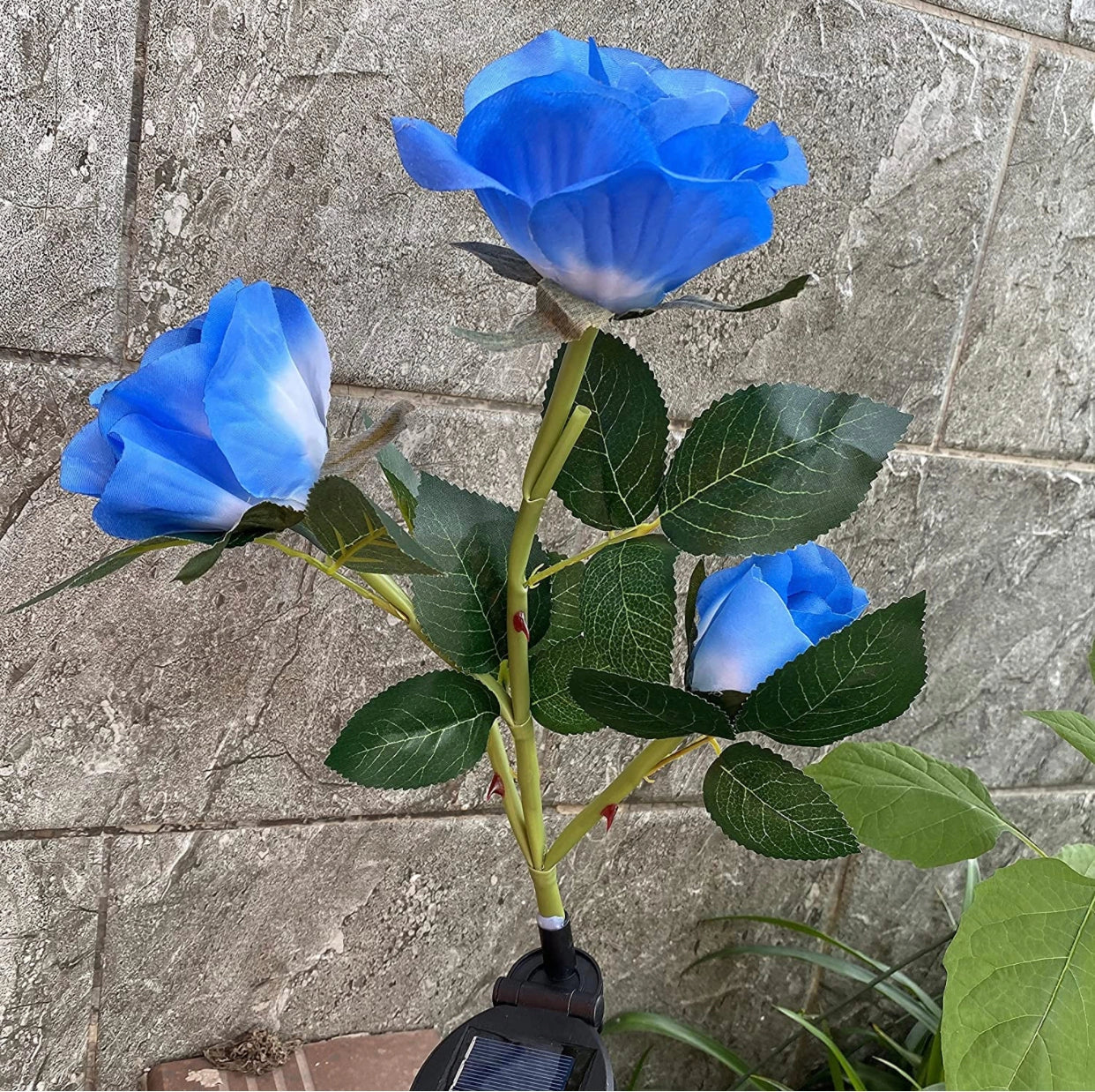 Solar LED Rose Lights Twin Pack - White roses glowing at night in a garden setting.