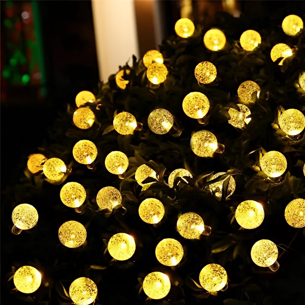 Solar string lights with IP65 waterproof RGB and white LEDs, featuring a long battery life, displayed with warm amber and white tones.