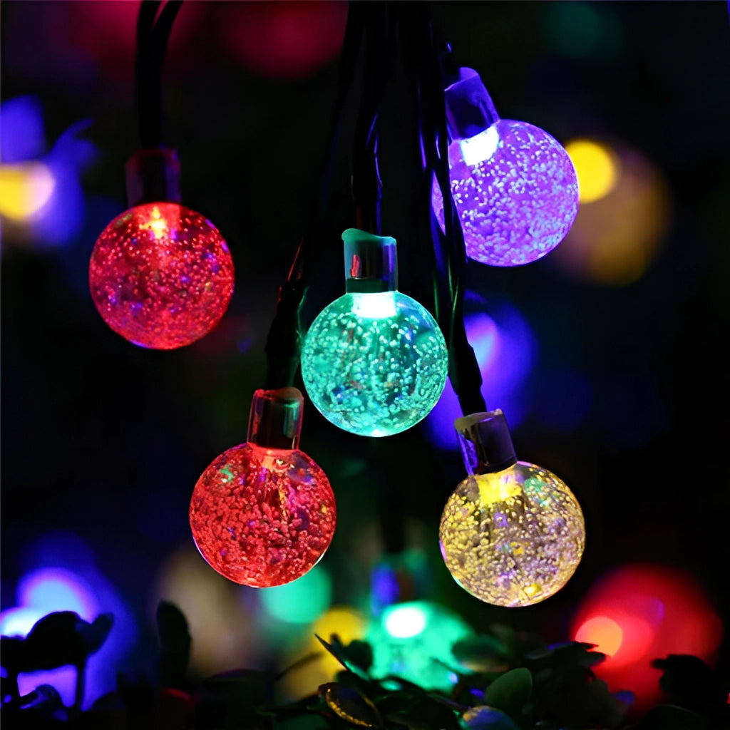 Solar string lights featuring IP65 waterproof RGB and white LEDs with long battery life, glowing in magenta and electric blue colors.