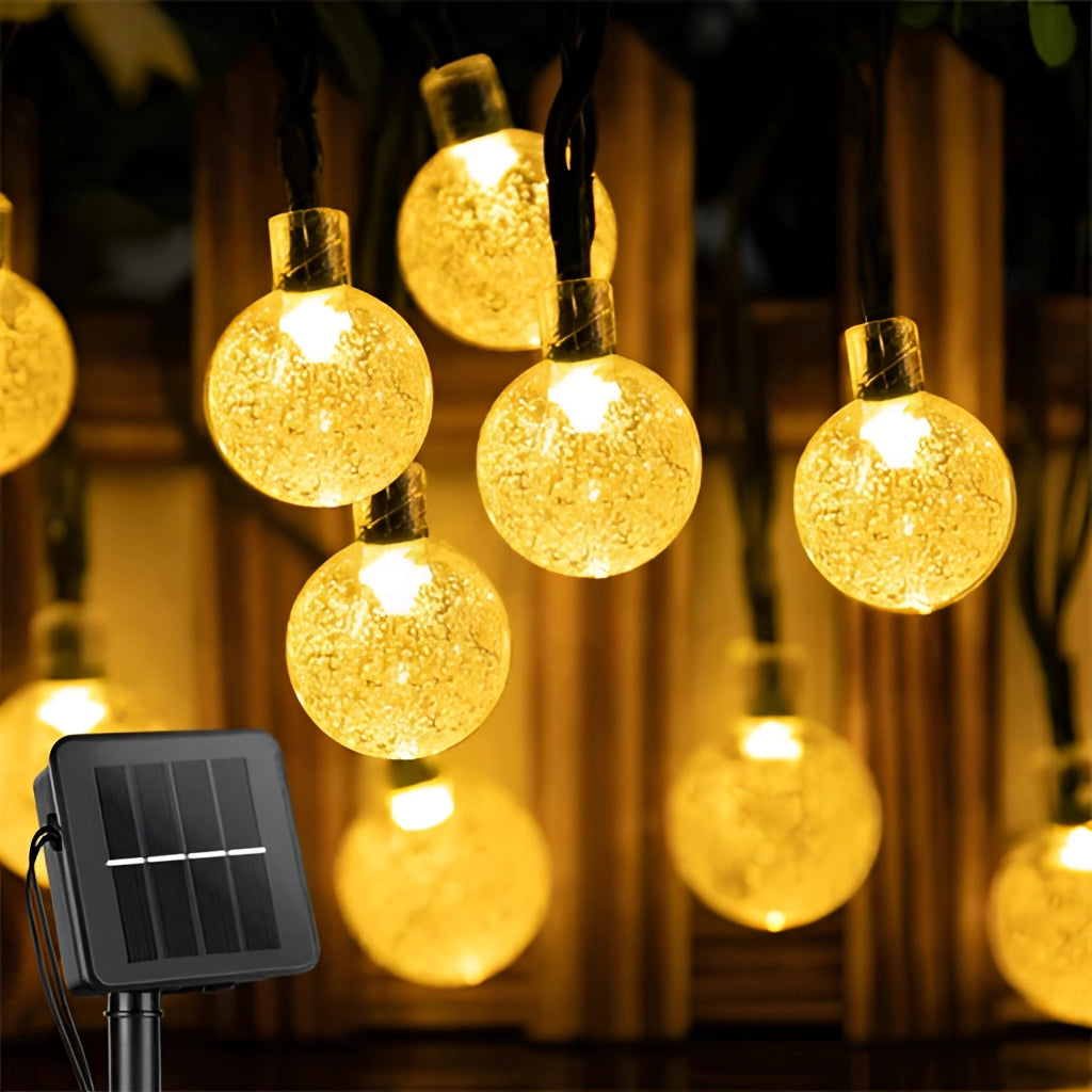 Warm white solar string lights, 72ft with 200 LEDs, outdoor LED, IP65 waterproof, illuminating in a garden setting.