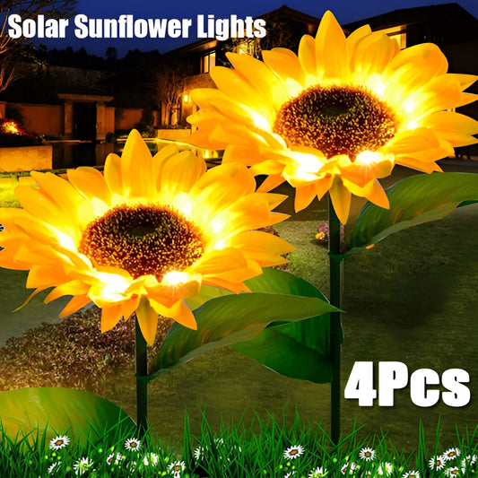 Pack of 4 solar-powered sunflower garden lights placed among green plants and foliage, illuminated by sunlight.
