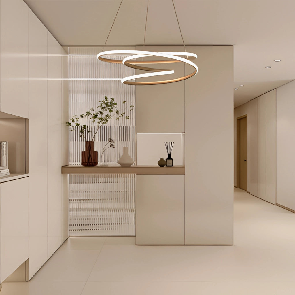 Modern Spiral Pendant Light with Warm Illumination in Elegant Aluminum Design, showcased in a stylish interior setting with wooden flooring, a potted plant, and a clean wall background.