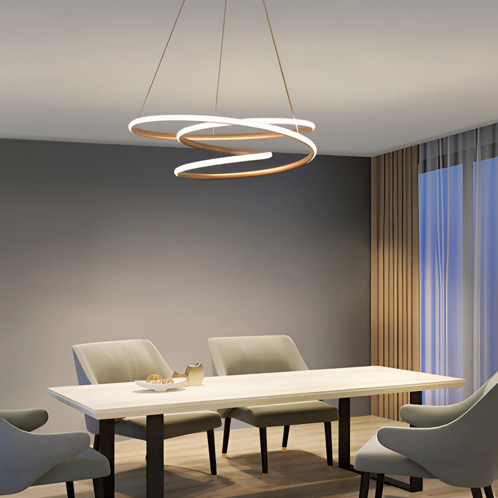 Modern aluminum spiral pendant light with warm illumination, hanging above a wooden table in an elegantly designed interior space.