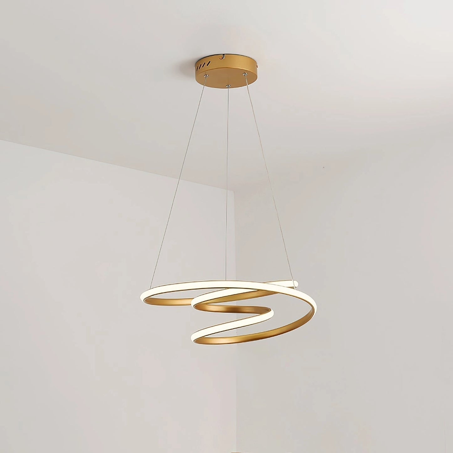 Elegant aluminum spiral pendant light with warm illumination, featuring a modern circular design, suspended as a ceiling fixture.