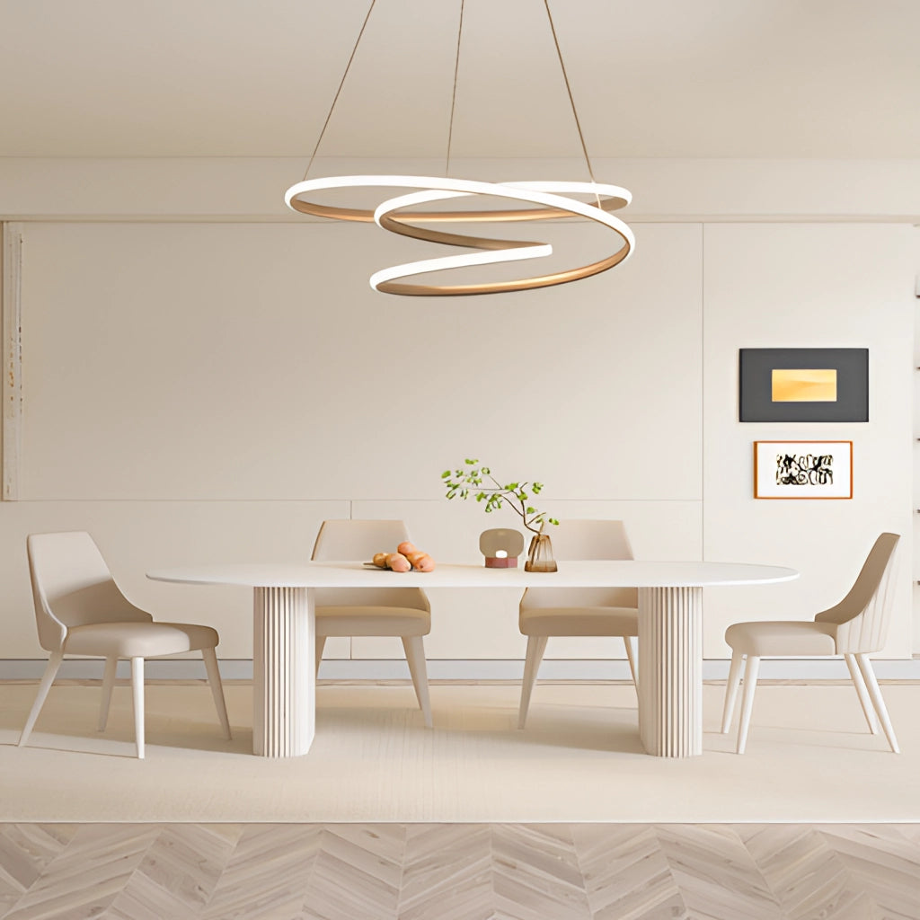 Elegant Spiral Pendant Light with Warm Illumination, Modern Aluminum Design, Hanging Above a Wooden Table and Chairs in a Beautifully Furnished Interior with Plants and Beige Flooring.