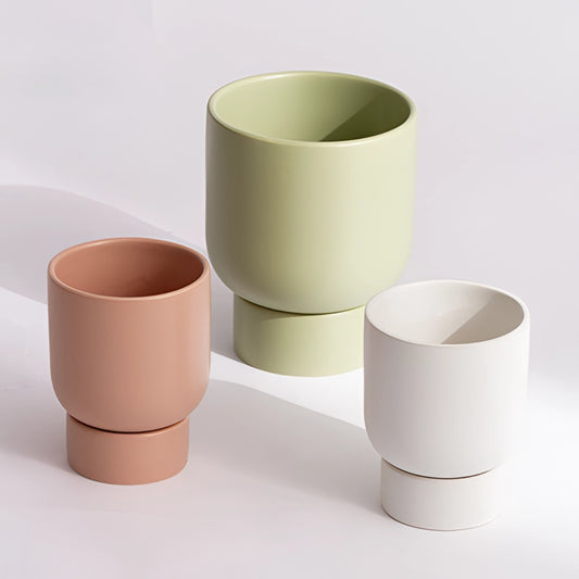 A white ceramic flower pot with a stacked design, suitable for garden and bonsai use, displayed on a table.