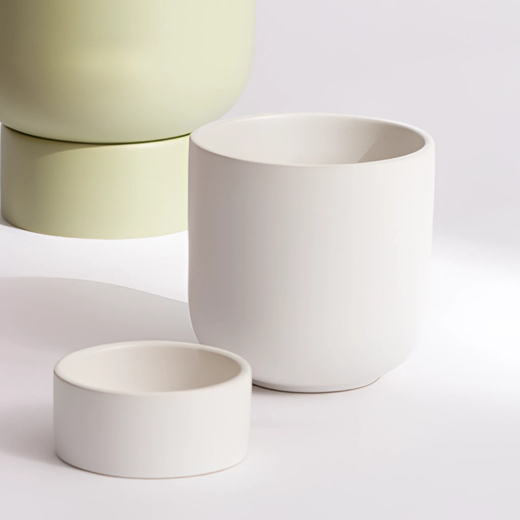 Ceramic stacked flower pot for garden and bonsai, displayed on a table with elegant porcelain finish resembling a cylinder.