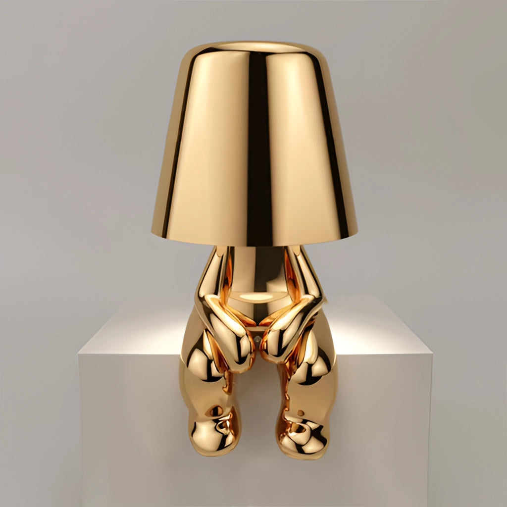 Stylish Thinker Lamp - Lars variant in gold, featuring a wooden base, metal accents, and a rectangular lampshade, perfect for desk or nightstand lighting with an artistic touch.